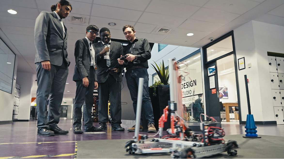 Teacher and students controlling a robot