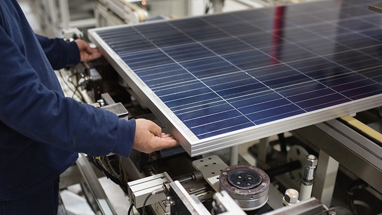 person working on manifacturing of a solar panel