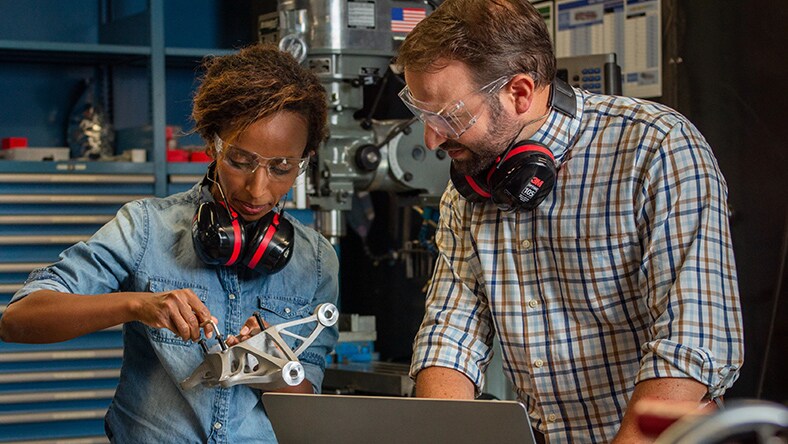 a female and a male engineer working together on a 3D model