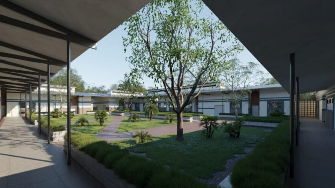 Rendering of the MCOE courtyard, viewed from ground level at the one of the courtyard's corners. Courtyard is intersected by paved walkways, surrounded by green grass, small shrubs, and a medium-sized tree with thin leafs in the foreground. Sidewalks extend from the rendering POV, diagonally to the left and right, under overhangs supported by thin black posts.