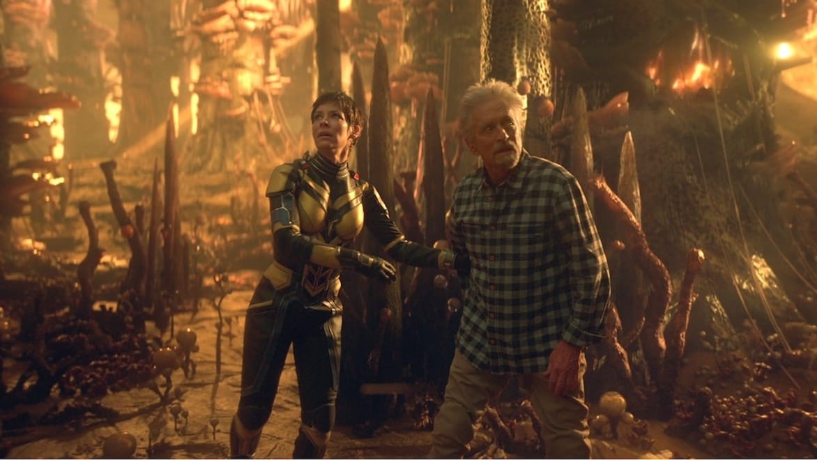A still from Ant-Man and The Wasp: Quantumania shows two people walking in a procedurally generated magical forest