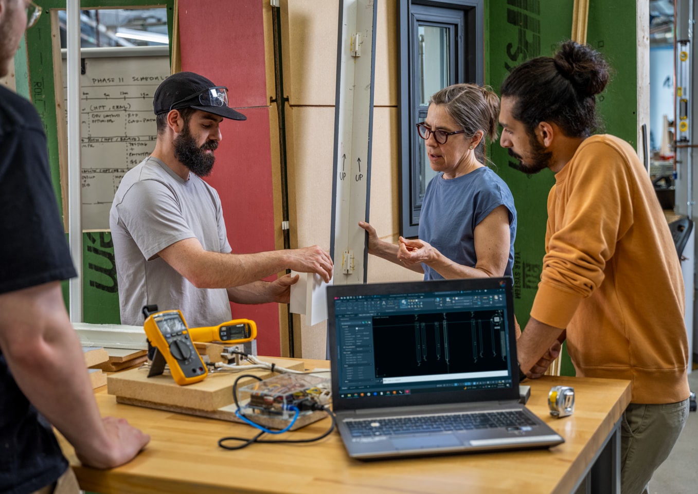 Team working together on a CAD design while preparing for an AutoCAD software update.