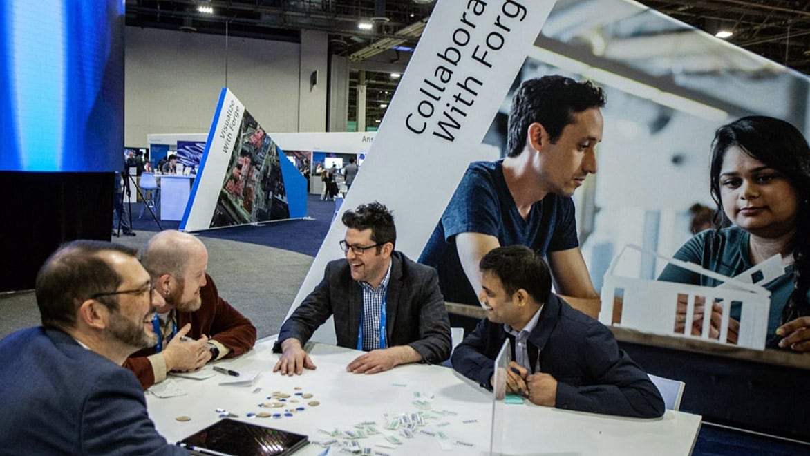 Group of people collaborating at a table during a professional event