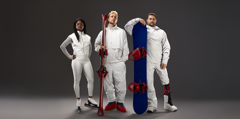 U.S. Olympian Erin Jackson, U.S. Olympian Colby Stevenson, and U.S. Paralympian Mike Schultz standing with their athletic equipment.
