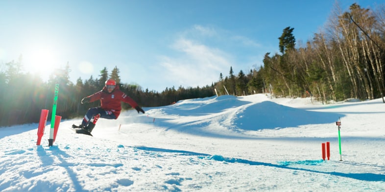 Mike Schultz is snowboarding down a mountain. 