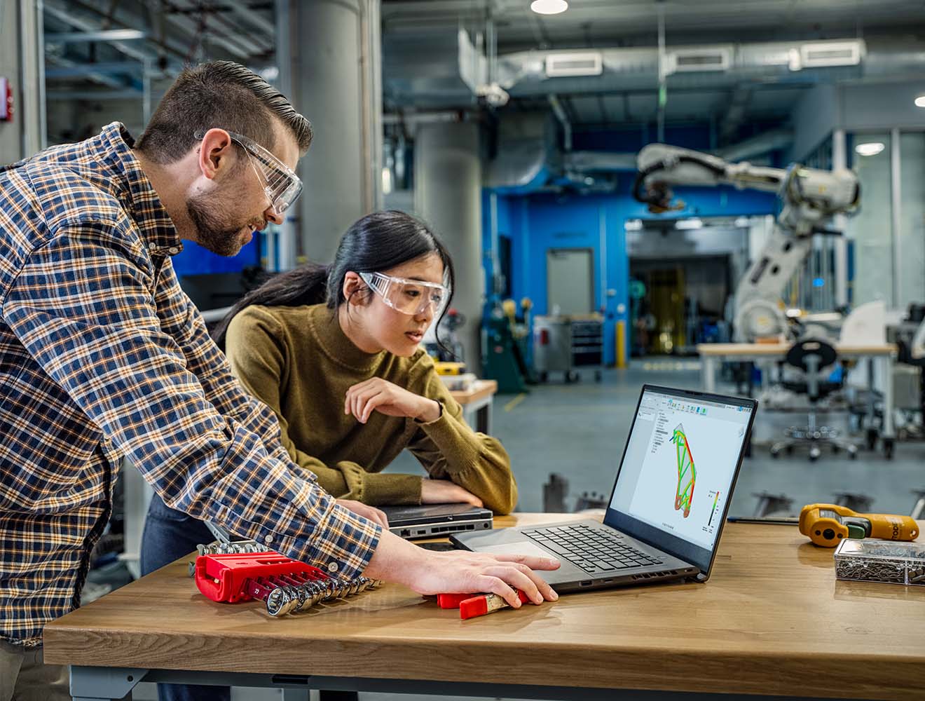Engineers collaborating on product design in a manufacturing facility.