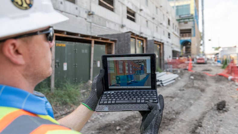 construction worker using software in the field