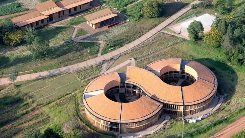 Five people on a construction site watching a plan