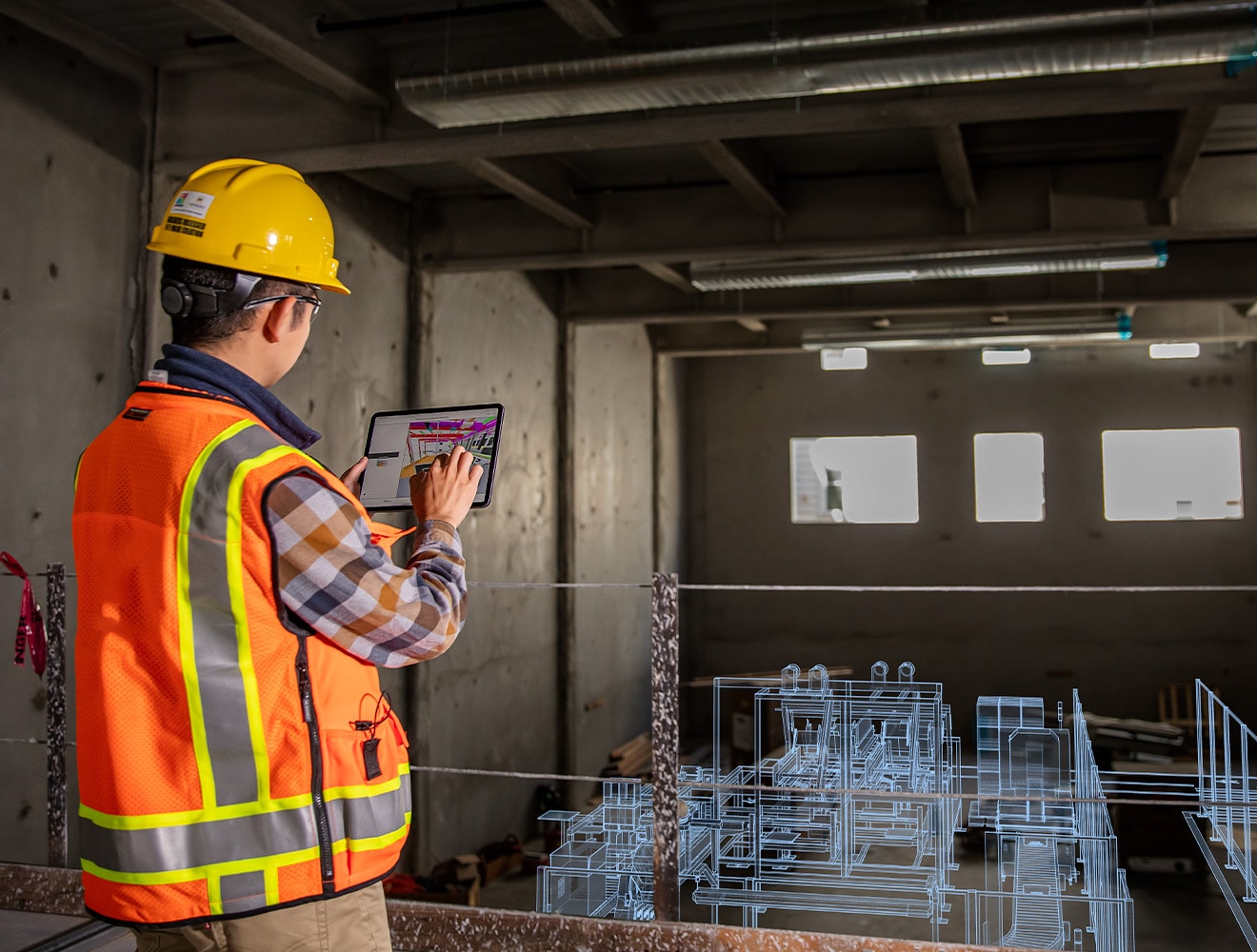 Two engineers looking at a digital factory model