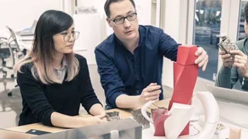 Two people look at a model