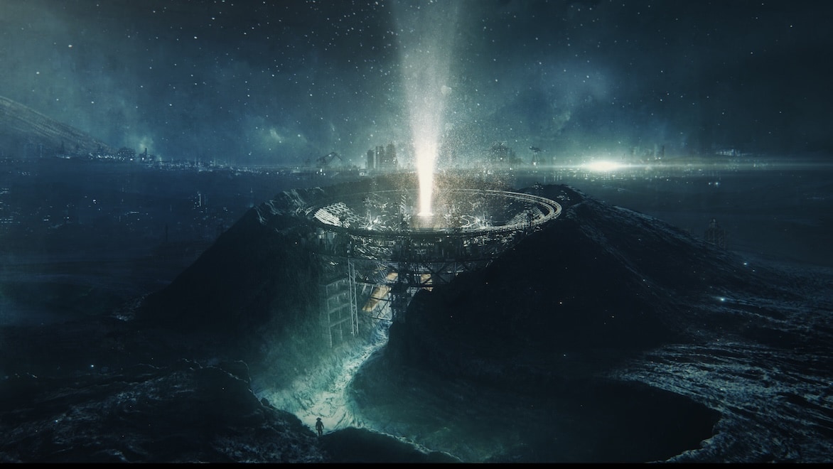 A large circular structure emits a strong beam of light directly into the night sky on a dark alien world.