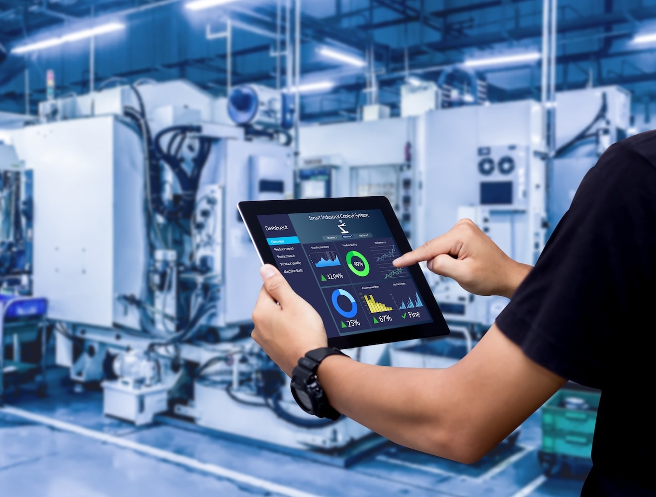 A man surveys data on an iPad screen in an industrial plant.