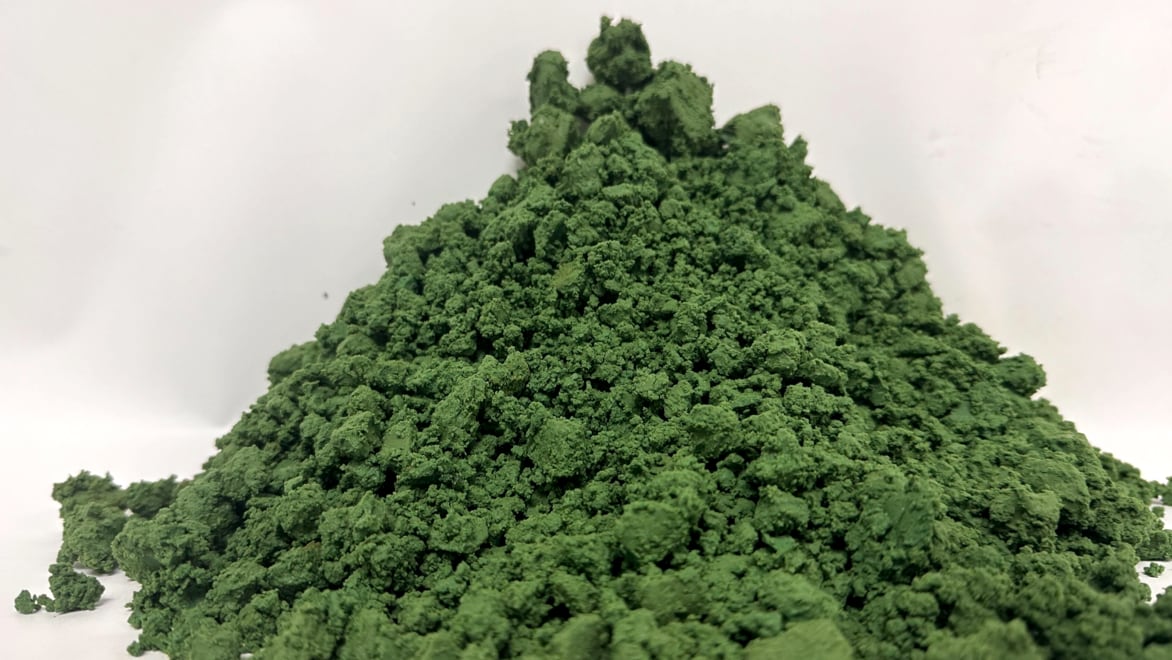 Close-up picture of Nth Cycle’s Mixed Hydroxide Precipitate (MHP). Conical pile of brown soil-like material.