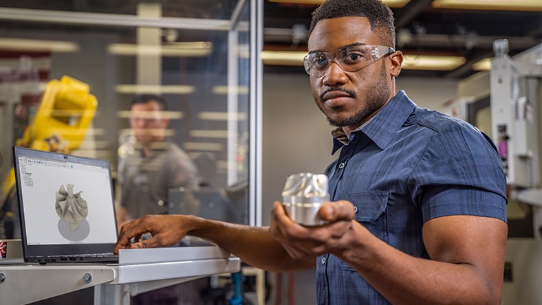 Engineer inspecting a manufactured component in a production facility.