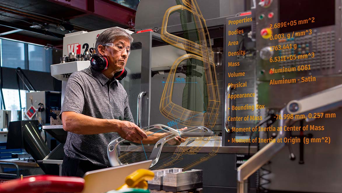 Engineer using digital design data in a manufacturing environment.