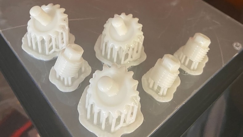 A close-up of several replacement water utility flow meters printed using stereolithography.