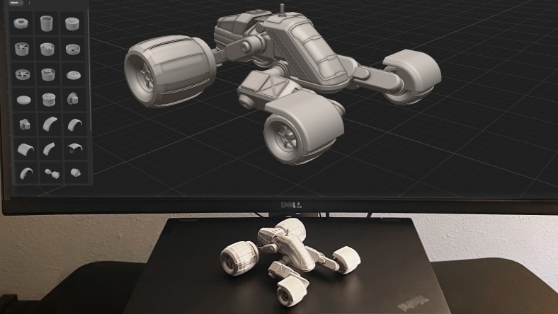 A 3D-printed car model displayed in front of its digital counterpart in Project Falcon