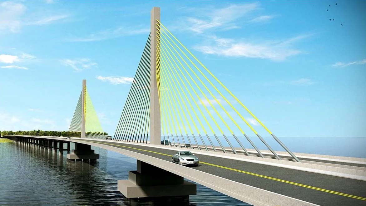 An image shows a silver car driving over a long bridge.