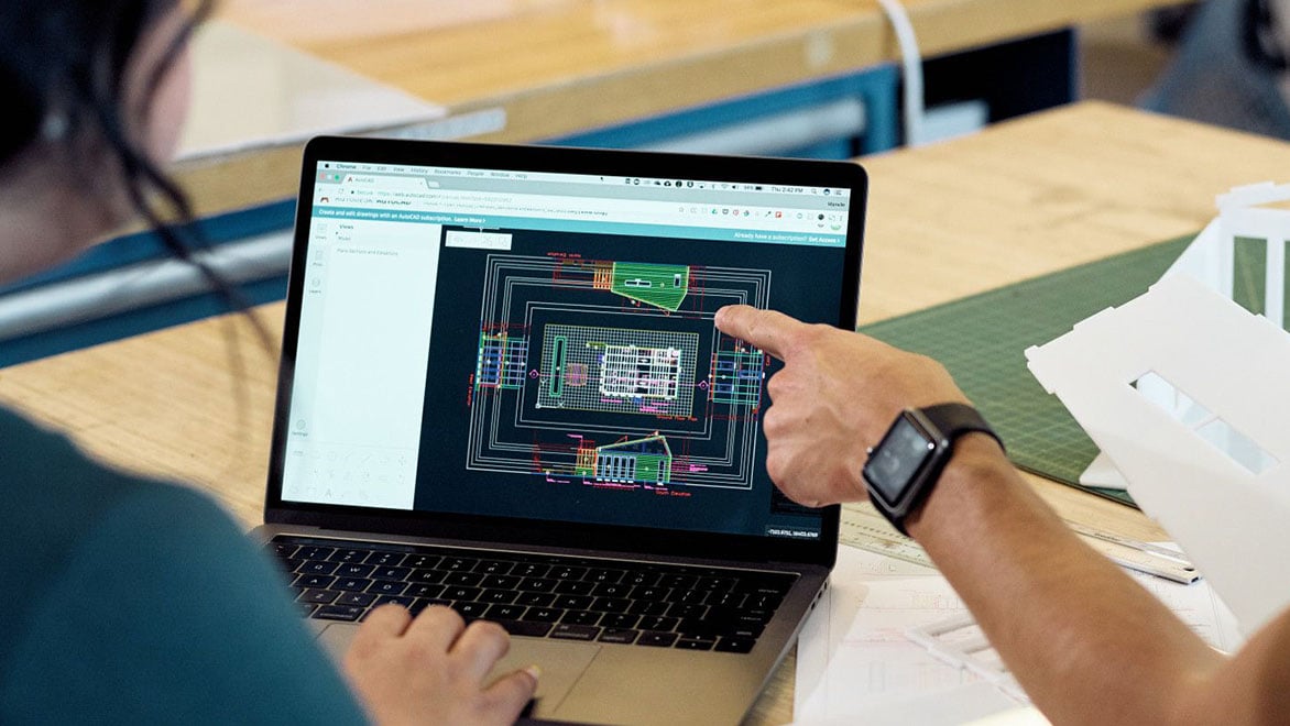 Architects working with AutoCAD to laser cut architectural models.