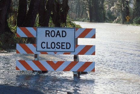 Road closure sign on a flooded road