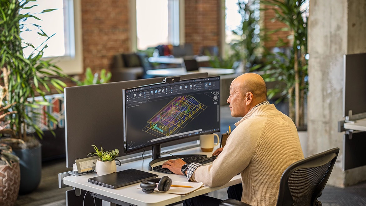 Man using AutoCAD in an office environment.