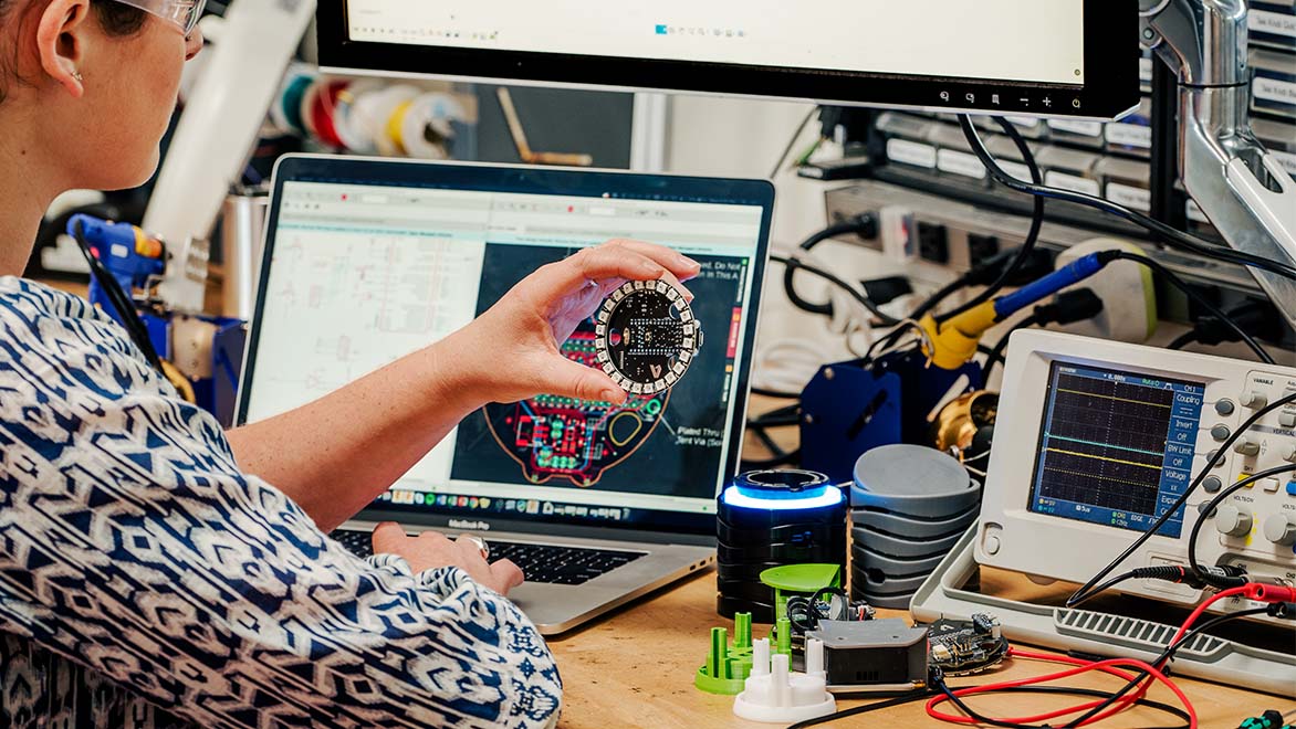 Woman working in the electrical workshop using Fusion.