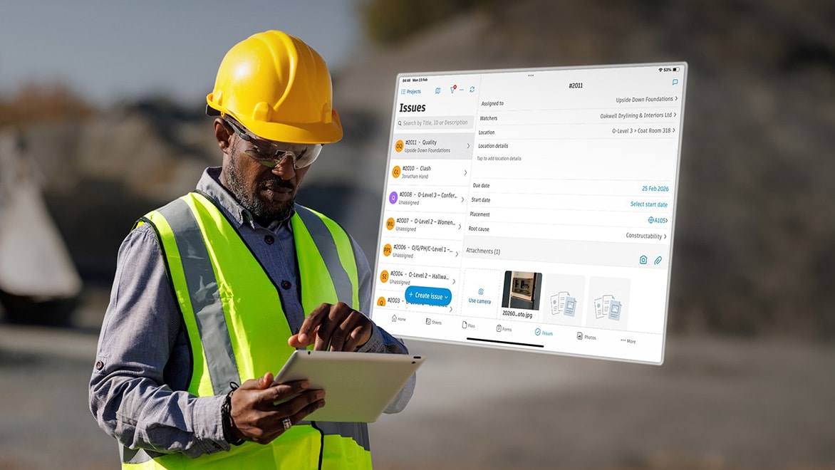 Construction worker using tablet for jobsite issue tracking and field management.