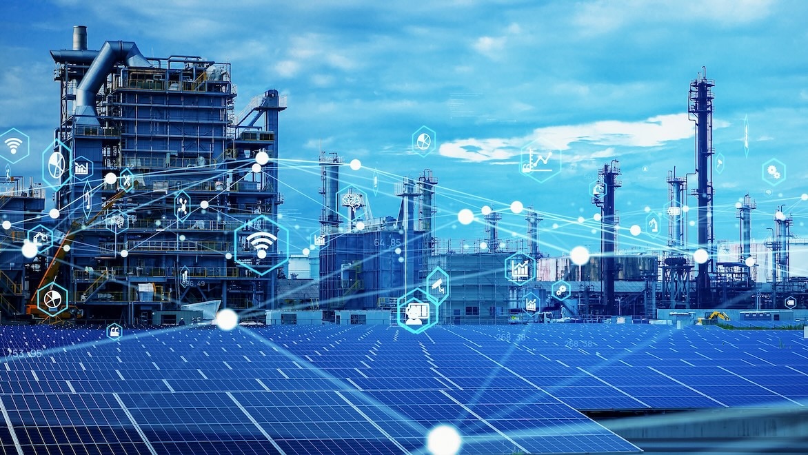 1645796171 An image of industrial buildings is overlaid with interconnected graphical icons representing Industry 4.0 and the Industrial Internet of Things.