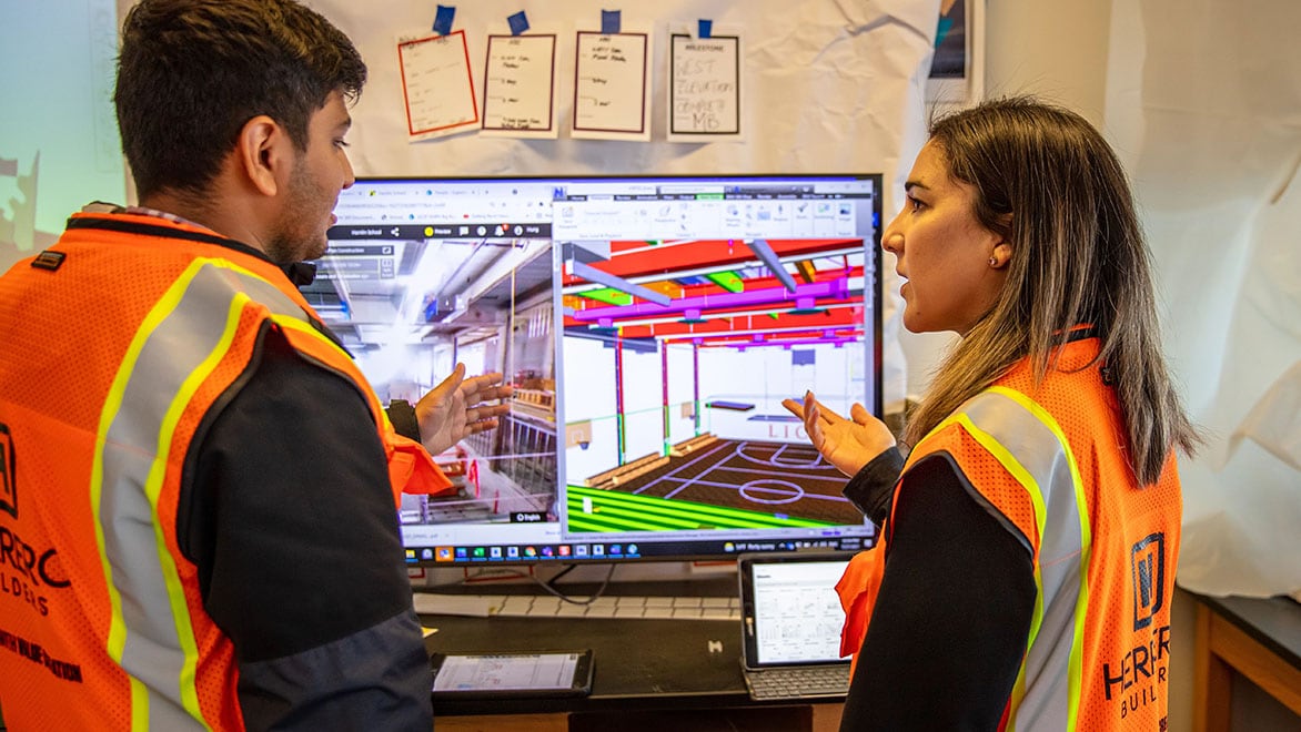 Construction team reviewing on screen for coordination.