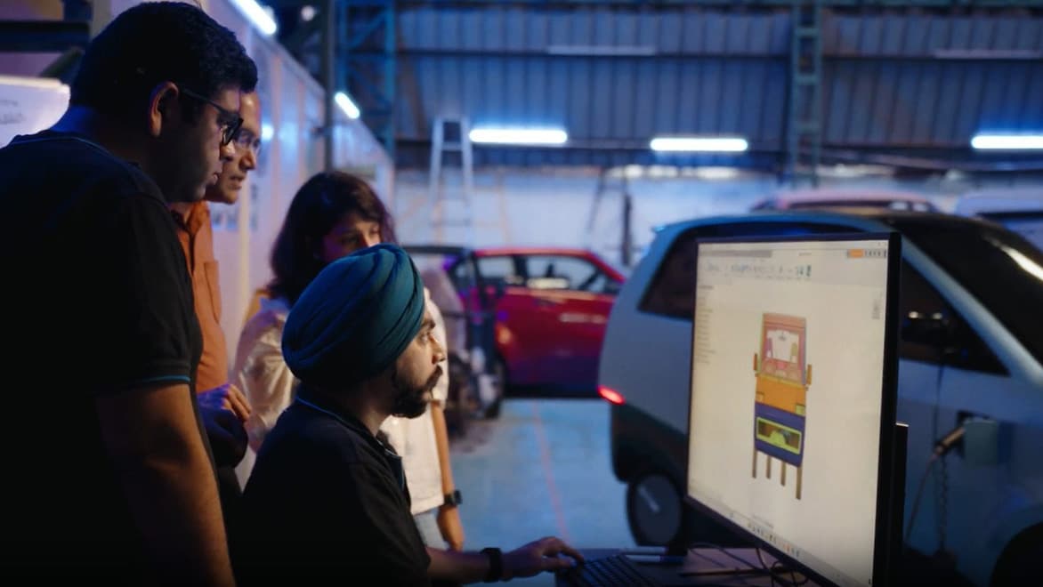 Professionals collaborating in an EV manufacturing workshop