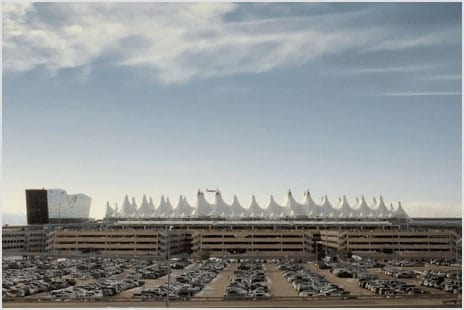 Denver airport parking lots and terminal beneath distinctive white peaked roof tents.