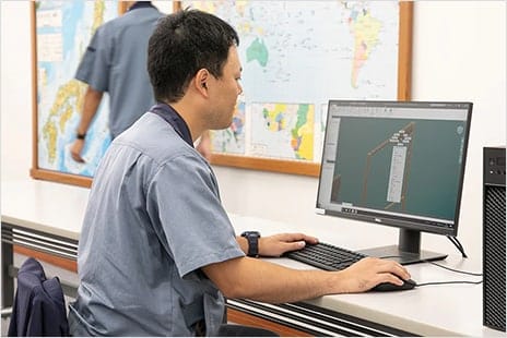 Engineer using iLogic in Inventor on computer