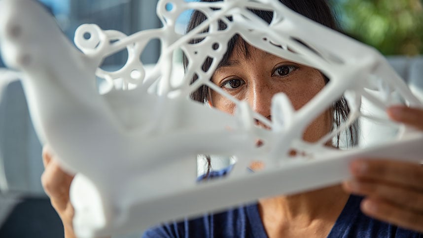 Woman examining a generatively designed part at the Autodesk San Francisco Technology Center. 