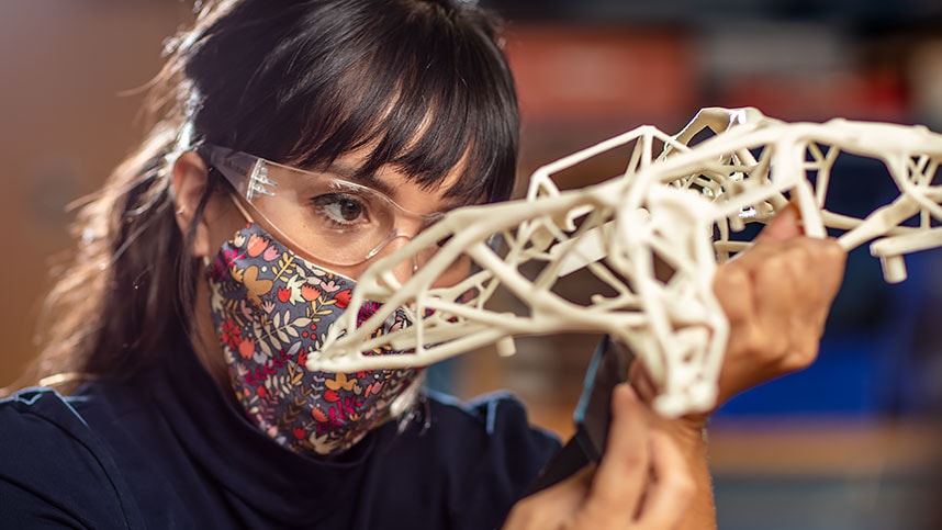 Woman working with a generatively designed part at the Autodesk San Francisco Technology Center.