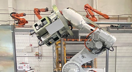 A manufacturing robot on a platform landing in a technology center. 