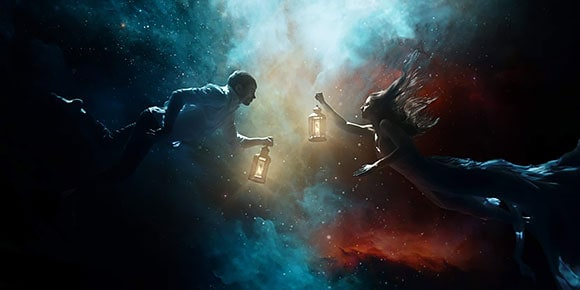 Man and woman holding lanterns in space backdrop