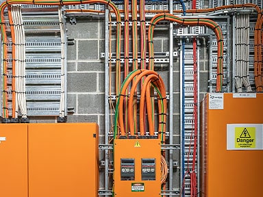 An electrical hub with orange boxes and a control center  