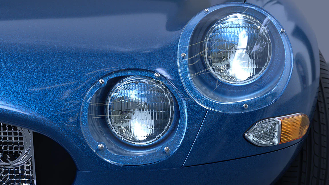 Close-up view of the left headlights of a bright blue car