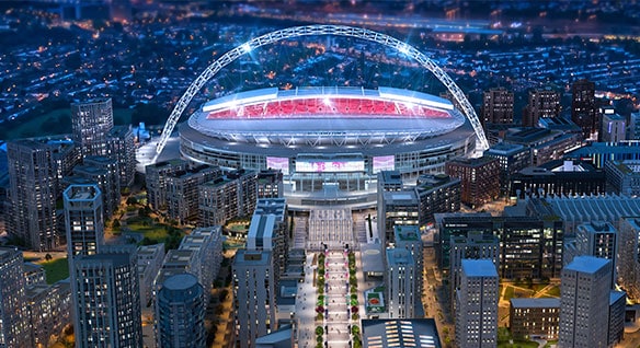 Detaljerad rendering av en föreställd version av Wembley-arenan på natten i ett upplyst London 