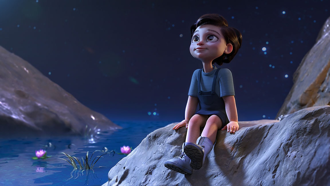 Lille barn, der sidder ved en dam og kigger drømmende op på nattehimlen.
