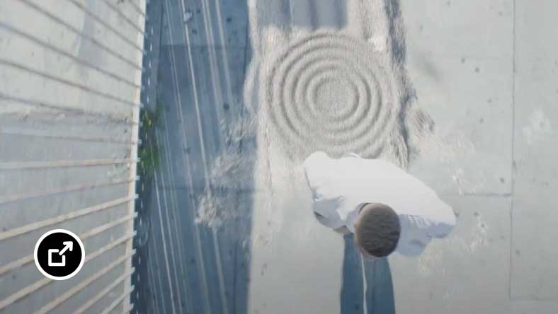 Man walking on sidewalk covered in moving sand