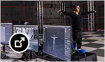 Woman looking at monitors as motion is being captured in studio 