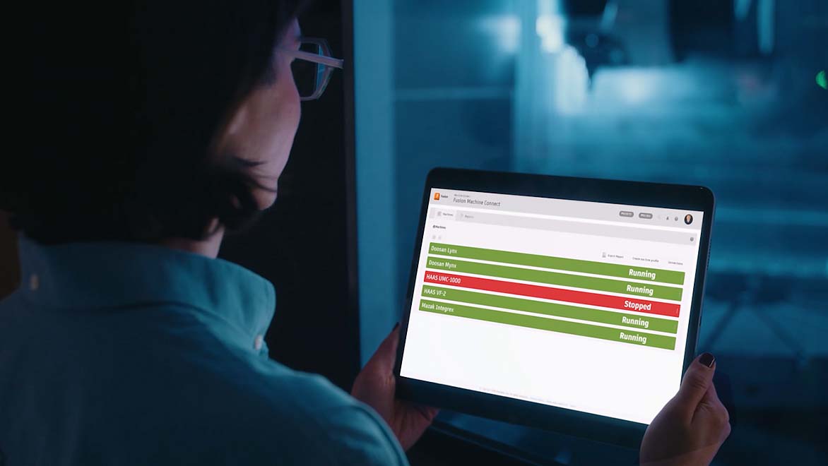 Image: A production manager is using Fusion Machine Connect on a web-connected tablet to monitor machine status