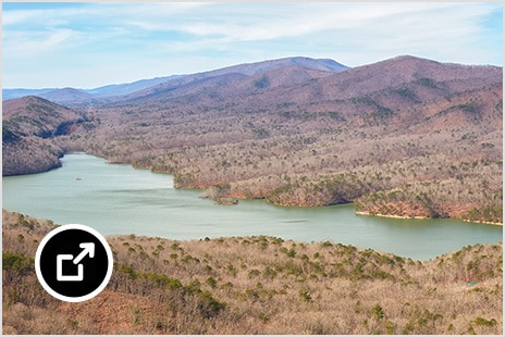 Carvins Cove reservoir and Allegheny mountains from the Appalachian Trail show water among a vast, tree-covered mountainside.
