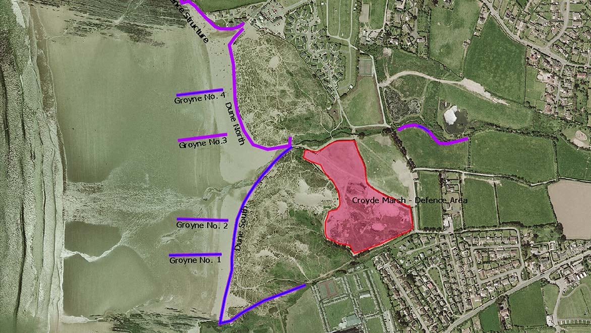 GIS software in Autodesk InfoAsset Manager displays an aerial map with annotations for groynes along a coastline. 