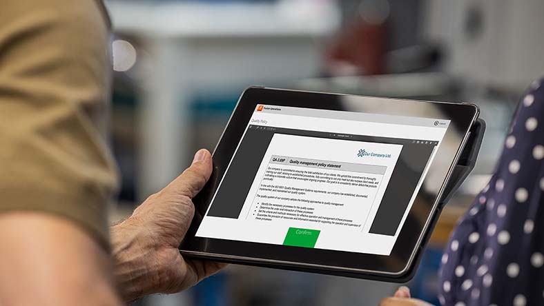 Image showing workers accepting quality policy documentation using Autodesk Fusion Operations.