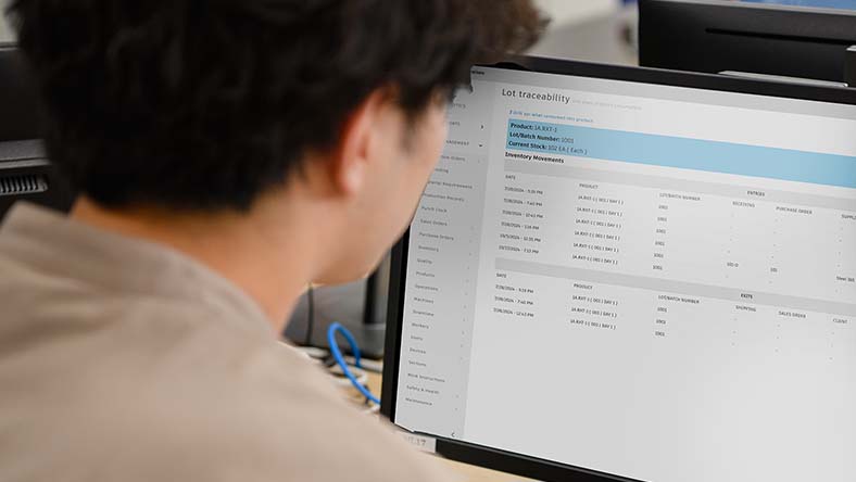 Image showing an employee using Autodesk Fusion Operations to track the history of a product through their production floor.