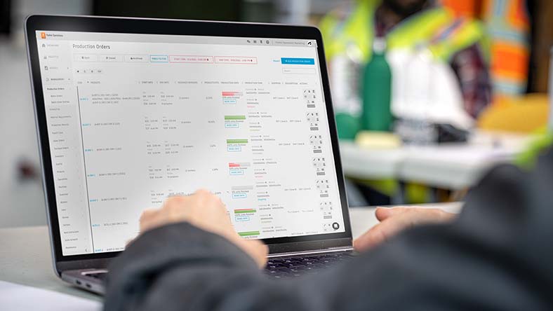 Image showing a worker using Autodesk Fusion Operations to create and manage production orders.