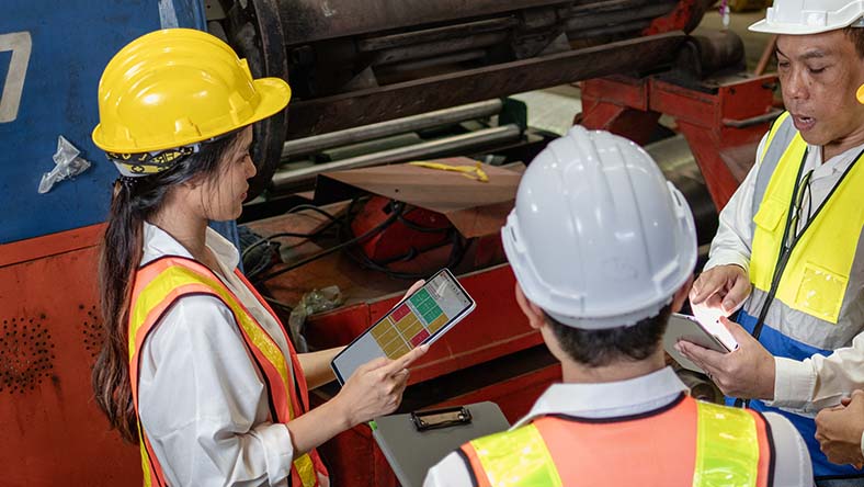 Image showing production workers using Autodesk Fusion Operations for managing machines, workers, and processes.