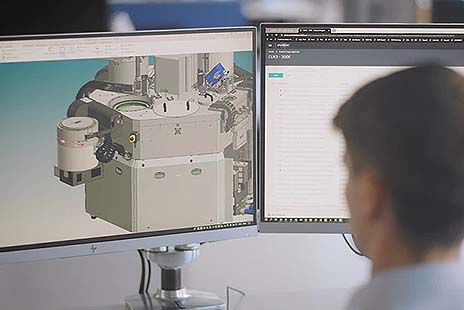 Professional uses Autodesk PLM software on dual monitors